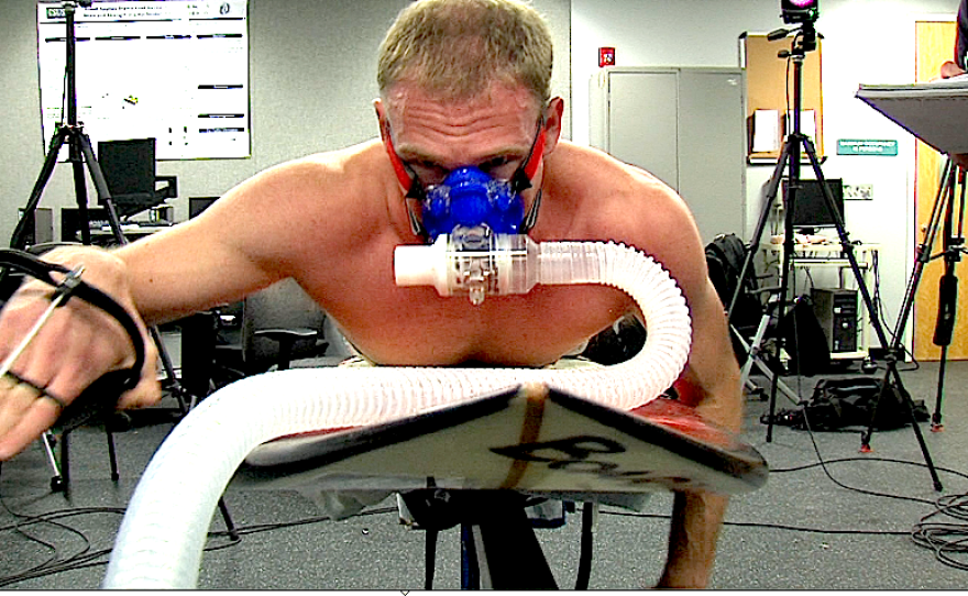 Ross Edmunds simulates paddling in the Cal State San Marcos biomechanics lab. It's part of a study that aims to find out whether recreational surfing is a strenuous exercise. 