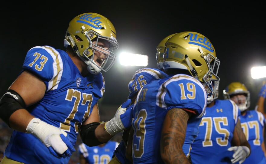UCLA players celebrate during a game against the Arizona Wildcats at the Rose Bowl last year in Pasadena, Calif. Gov. Gavin Newsom has signed a bill paving the way for college athletes in the state to hire agents and sign endorsement deals.