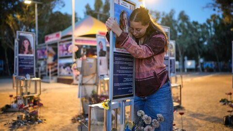 Raz Zarfati, sister of Ron Zarfati who was killed in the Oct. 7, 2023, Hamas attack on Israel, attend a memorial marking the third anniversary of the attack at the Nova music festival site near Kibbutz Reim, southern Israel, Wednesday, Oct. 7, 2026.