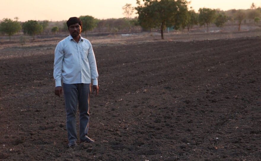 Dnyaneshwar Jadhav, whose younger brother killed himself, stands in his fields and says in a bid to survive he switched from cultivating water-guzzling sugar cane to less water intensive cotton. But the farm well, 60 feet, is dry and the ground water levels have sunk to new lows.