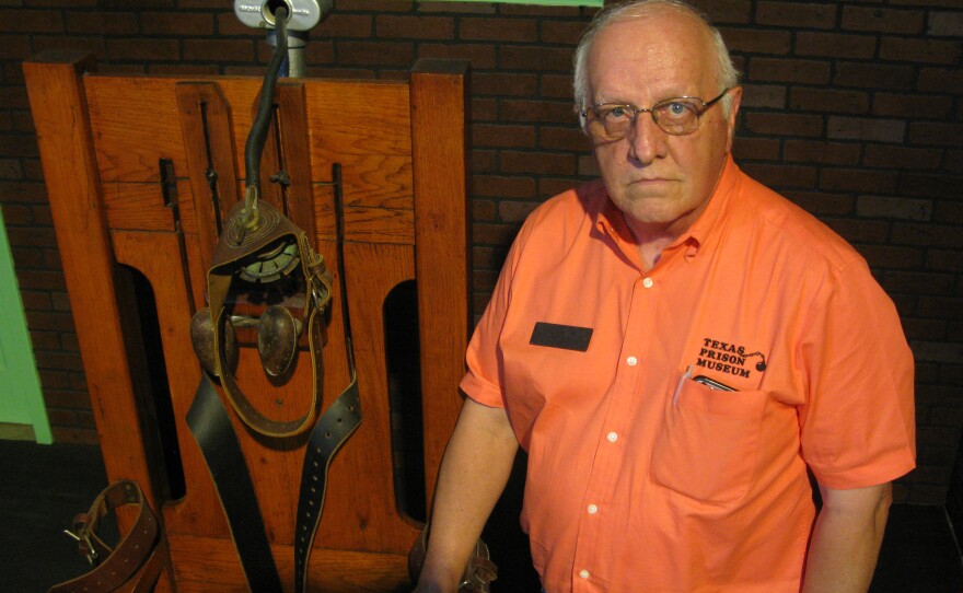 Texas Prison Museum Director Jim Willett with the retired electric chair, "Old Sparky," the most popular exhibit in his museum.