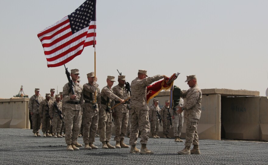Regimental Combat Team 7 cases its flag during their mission's closing ceremony in Helmand Province, Afghanistan.