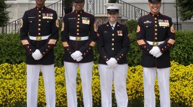 Marines demonstrate the current male and female dress blue uniforms as well as one prototype for the new female dress blue coat at Marine Barracks Washington May 15, 2013. 