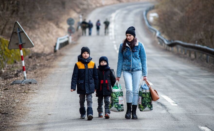 A woman and two children leave Ukraine after crossing the Slovak-Ukrainian border in February.