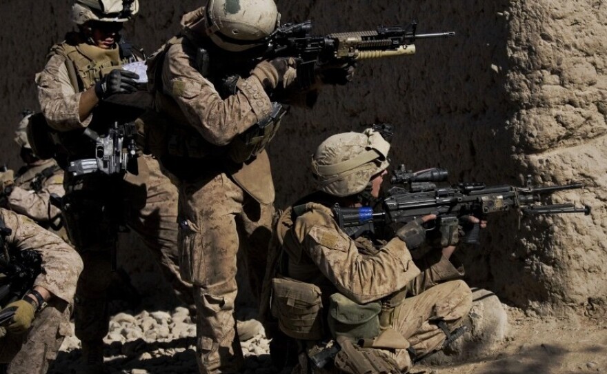 Marines take cover as a shot is fired last November in Sangin, Afghanistan.