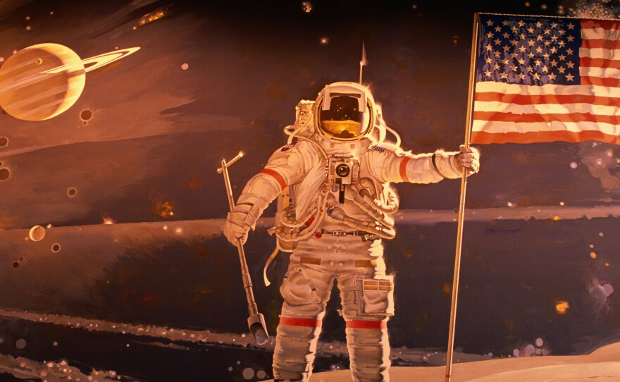 Astronaut holding American flag in space mural by Robert McCall, National Air and Space Museum.