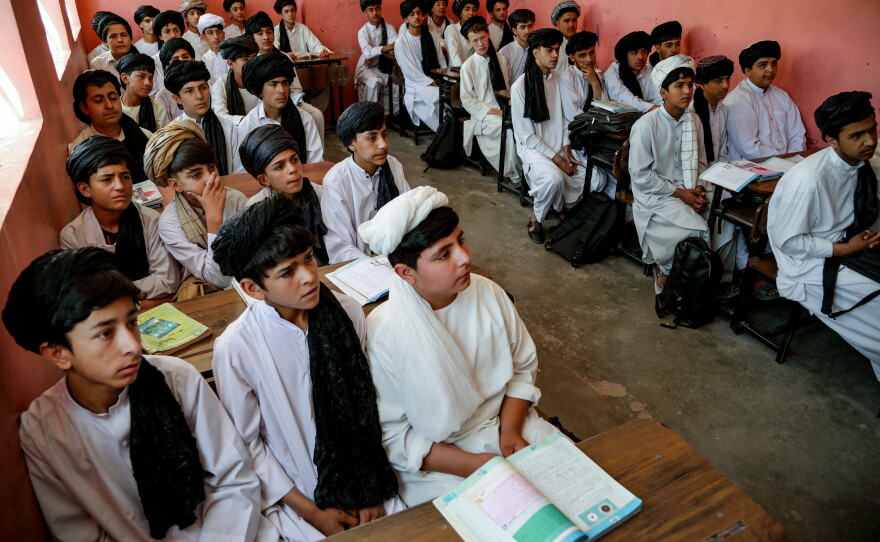 Afghan school boys wear Taliban-imposed uniforms of turbans and long tunics in a school in Herat. The government has put more focus on religious education since returning to power on August 15, 2021.