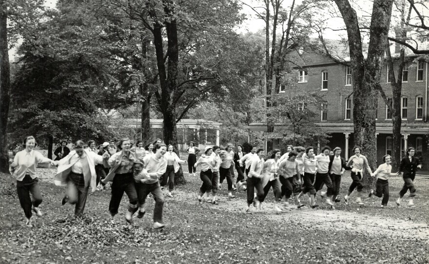 Hollins students run across campus on Tinker Day, 1950. One of the school's oldest traditions, the celebration is held on a surprise day each fall.