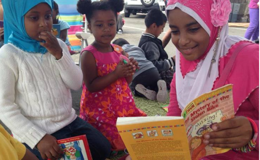This undated photo shows a mother and children reading at Traveling Stories in the San Diego Farmers Market.
