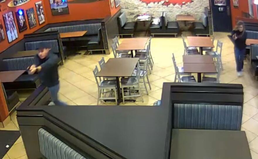 Detective Chase McKeown and Officer Nicole McKeown drew their guns and closed in on a robbery suspect in a fried chicken restaurant in Louisville, Ky., Saturday night.