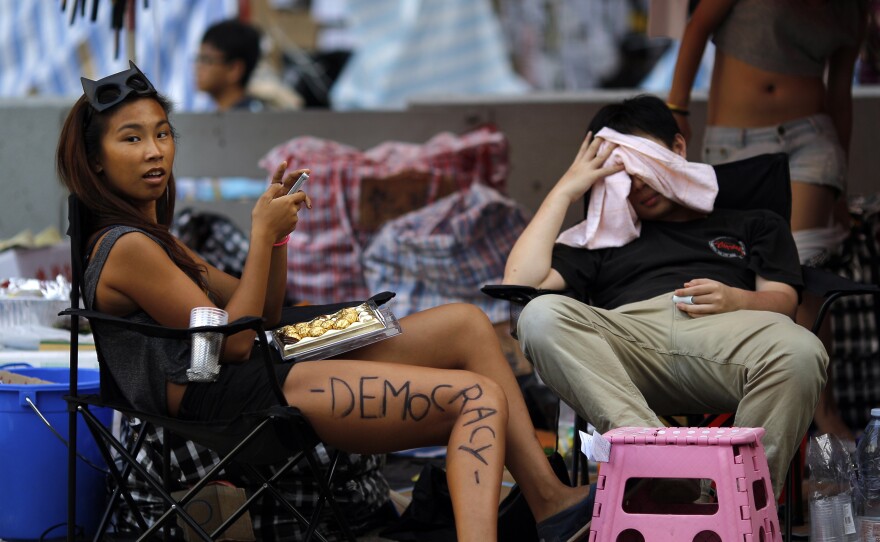 Protesters near the government headquarters in Hong Kong on Monday. Pro-democracy protests in Chinese-controlled Hong Kong appeared to be subsiding as students and civil servants returned to school and work after more than a week of demonstrations.