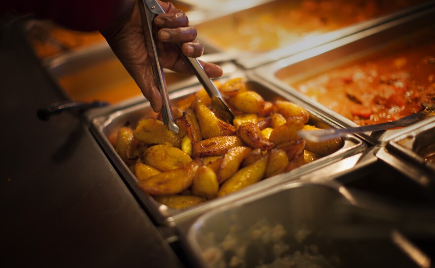 A worker prepares plantains at Pioco's Chicken.