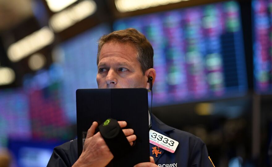 Traders work during the opening bell at the New York Stock Exchange on Thursday. Wall Street stocks opened sharply lower amid fears the coronavirus will grow into a significant international health crisis.
