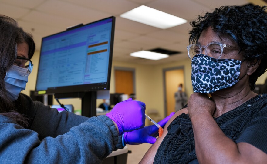 A woman receives the Moderna COVID-19 vaccine at the Bates Memorial Baptist Church in Louisville, Ky., on Feb. 12. Yet in many states, there are racial disparities in who has received the shot.