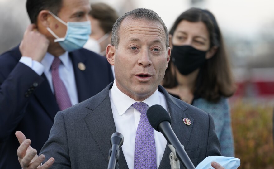 Rep. Josh Gottheimer, D-N.J., seen here at a Dec. 2020 press conference, is one of nine House Democrats threatening to withhold their support for a crucial budget resolution unless Speaker Nancy Pelosi first brings up a vote on the bipartisan infrastructure bill.