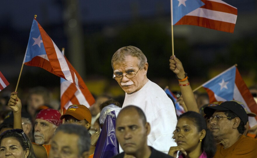 Puerto Rican activists show a picture of independence fighter Oscar López Rivera, center, jailed in the United States, during an event celebrating Revolution Day in Santiago, Cuba, on July 26, 2015.
