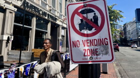 A man walks past a "No Vending Zone" sign in downtown San Diego, July 7, 2026.