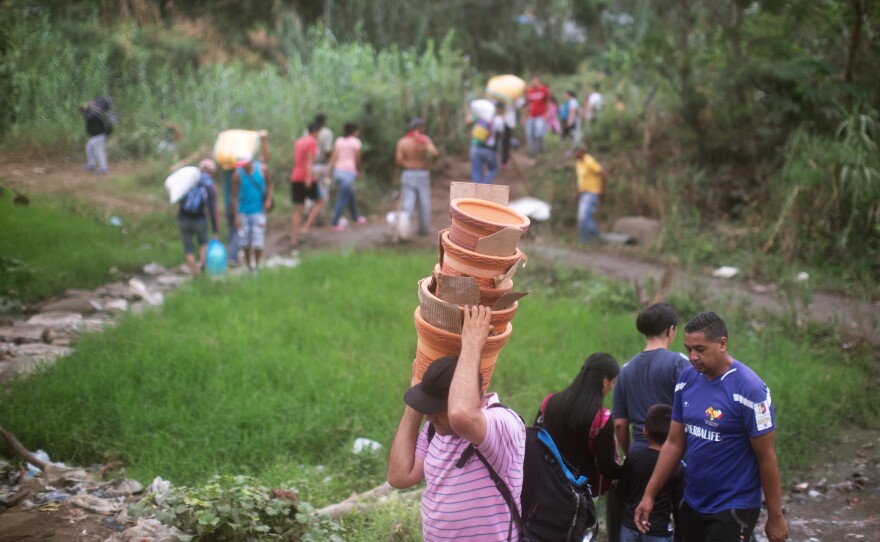 People walk from Venezuela to Colombia through an unauthorized border crossing in Villa del Rosario, Colombia. Some 3.4 million Venezuelans are seeking refuge abroad, with more than 1 million of them in neighboring Colombia, according to the United Nations refugee agency, UNHCR. Many people are leaving Venezuela by foot.
