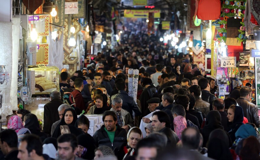 Iranians shop in Tehran's ancient Grand Bazaar on Jan. 16, 2016, the day many sanctions were lifted as part of a nuclear deal. President Rouhani called the deal a "golden page" in Iran's history.