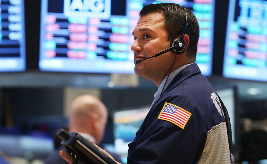 A trader works on the floor of the New York Stock Exchange on Wednesday. Stocks took a beating, with key indexes falling more than 2 percent before bouncing back slightly.
