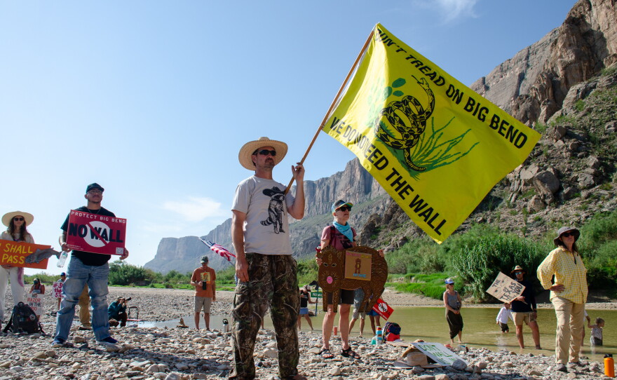 John Rakowitz waves a 'Don't tread on Big Bend' flag at a rally at Big Bend National Park, a pristine pocket of the West Texas border where the federal government is looking to build patrol roads, vehicle barriers and surveillance systems.