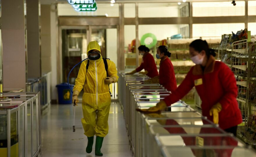 Employees spray disinfectant and wipe surfaces as part of preventative measures against the coronavirus at the Pyongyang Children's Department Store in March 2022.