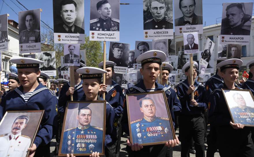 Participants walk in a march honoring Soviet soldiers of WWII, carrying portraits, in Sevastopol, Crimea on Saturday.