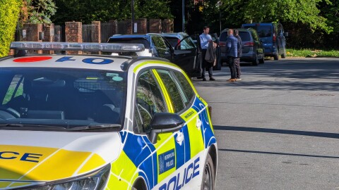 Police officers patrol at a cordon near Kenton United Synagogue in Harrow, a suburb of London, Sunday, April 19, 2026.