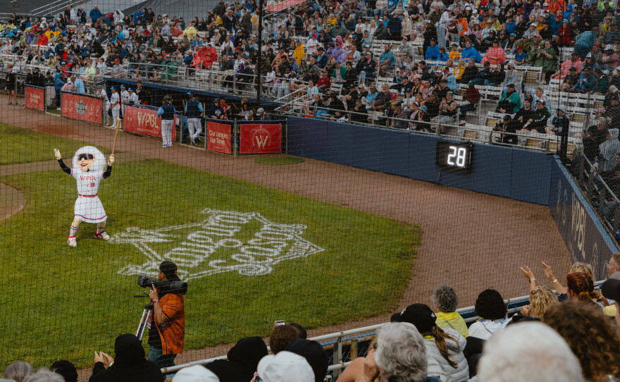 Maybelle the Mascot, designed in honor of veteran baseball player Maybelle Blair, entertains the crowd between innings of the WPBL's opening game on Saturday, Aug. 1.