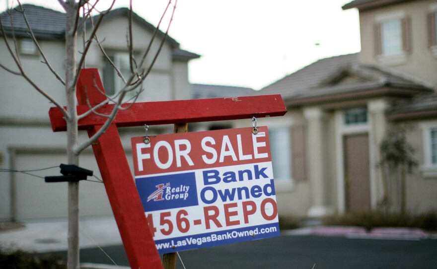 A for sale sign stands in front of a bank-owned home in Las Vegas in 2008.