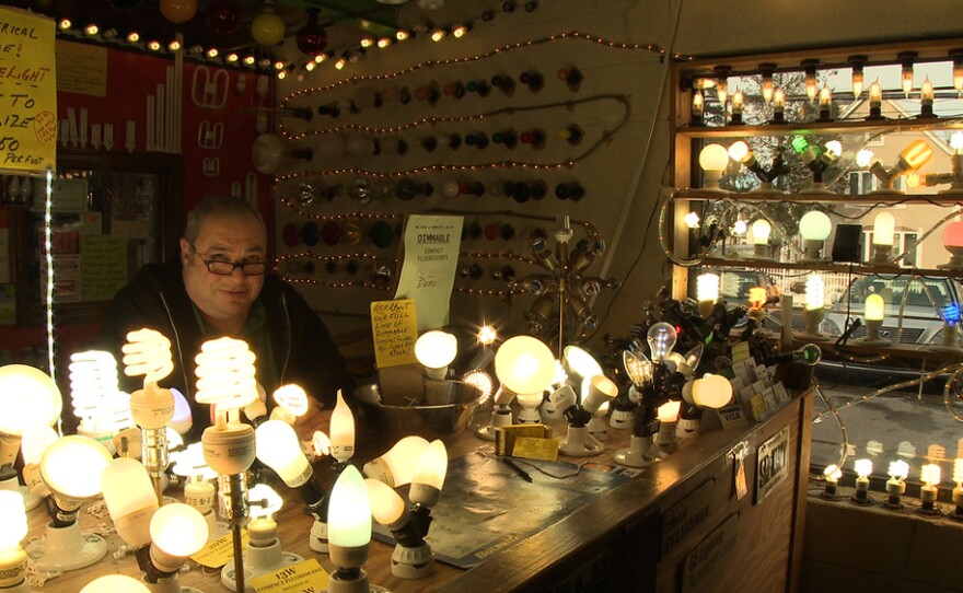 Lighting store owner Larry Birnbaum shows off his collection of antique and modern lighting.