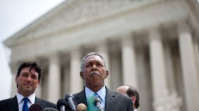 Otis McDonald (C), lead plaintiff, and his legal team speak to reporters after a ruling in their case seeking to overturn Chicago's ban on handguns.