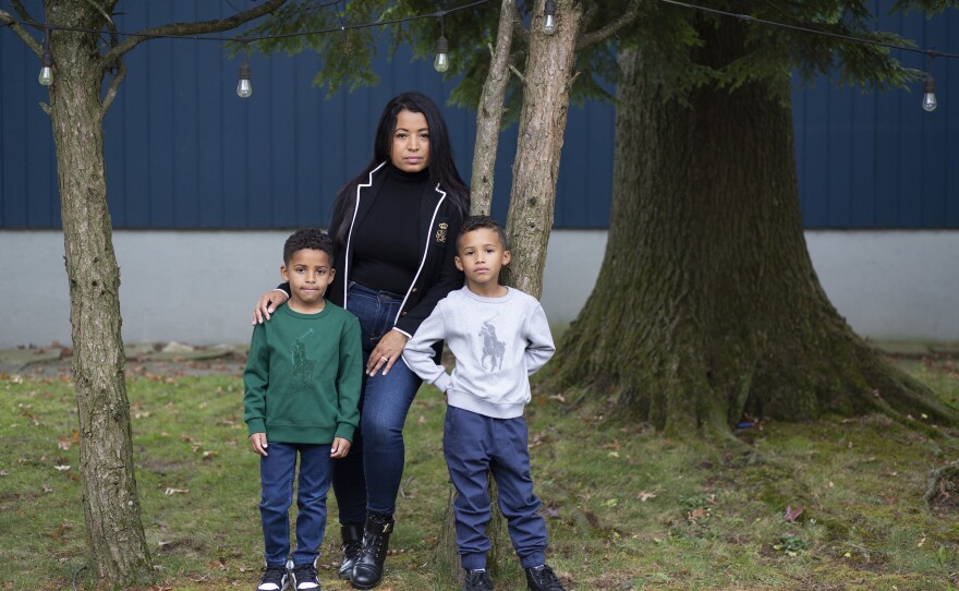 Farida Mercedes and her two sons Sebastian, 5, (left) and Lucas, 7, stand in their backyard in Fairlawn, N.J. Mercedes left her job as an assistant VP of HR at L'Oreal in August after working there for 17 years. As hundreds of thousands of women dropped out of the workforce in September, Latinas led the way, leaving at nearly three times the rate of white women.