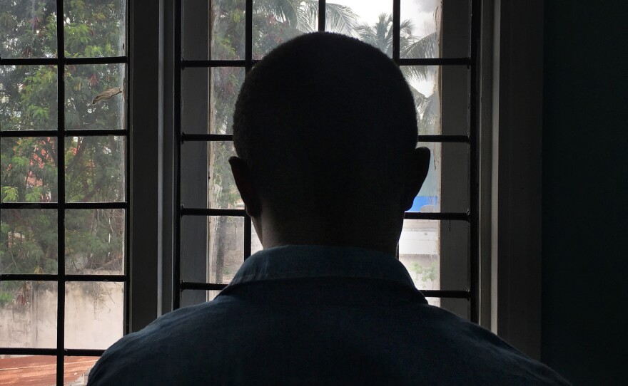 A gay man with HIV stands in a clinic in Dar es Salaam, Tanzania. He's been afraid to pick up his medicine because of the government's crackdown on the gay community.