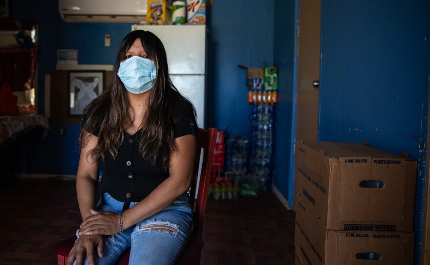 Entrika Zacarias sits in her home at Oasis Mobile Home Park in Coachella Valley on Aug. 23, 2023. Zacarias, a farmworker, lost four days of work during Hurricane Hilary. Her home was damaged and flooded from the heavy winds and rainfall.
