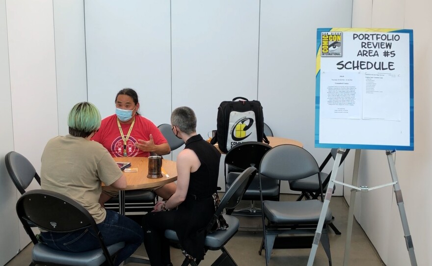 "Glitch" comics creators Alston Novak and Sarah Landauer get feedback from Committed Comics' Tom Doherty at San Diego Comic-Con.