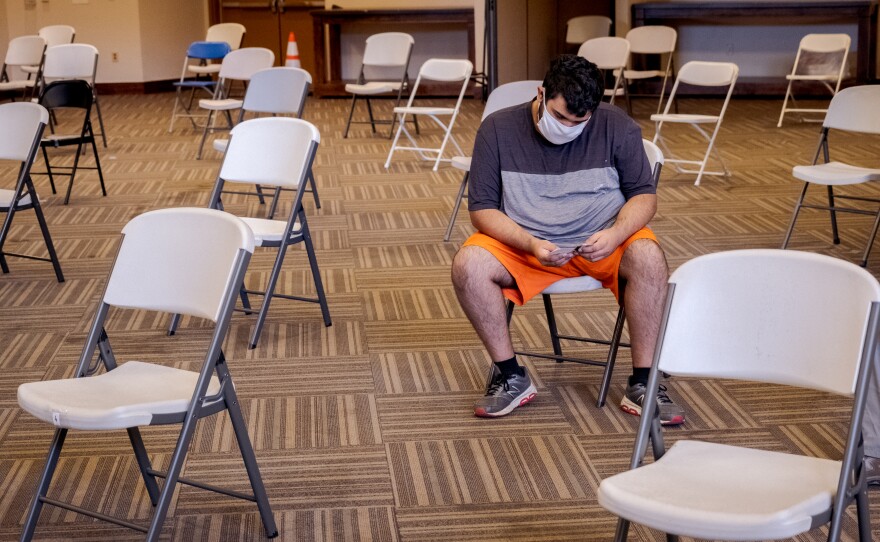 After Alan Chee Pantoja says that he waited to get his first does of the Moderna vaccine because he wanted to make sure there were no side effects, but now he is happy to get his vaccine.