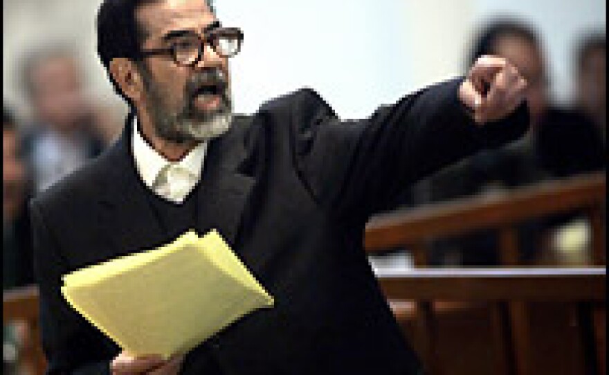 Former Iraqi President Saddam Hussien argues with prosecutors while testifying during his trial in Baghdad on Wednesday.