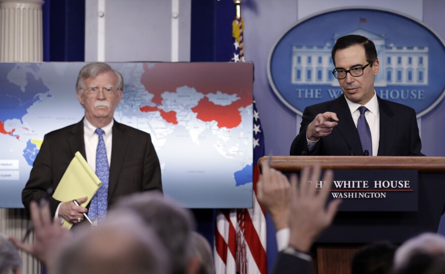 Treasury Secretary Steven Mnuchin (right) and National Security Adviser John Bolton announce sanctions against Venezuela at the White House Monday.