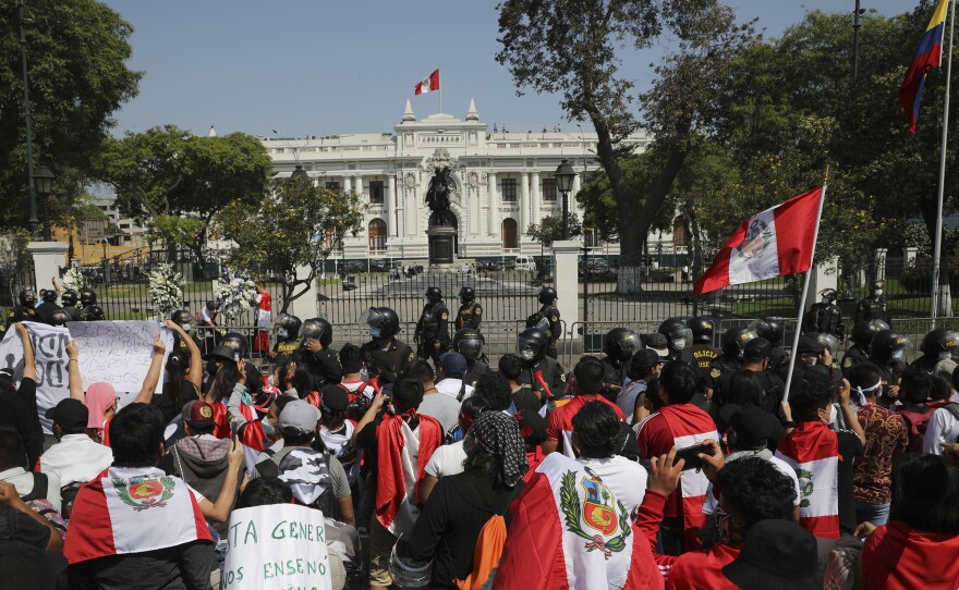 Protesters gather outside Congress in Lima, Peru, after interim President Manuel Merino announced his resignation following massive protests unleashed when lawmakers ousted President Martín Vizcarra.