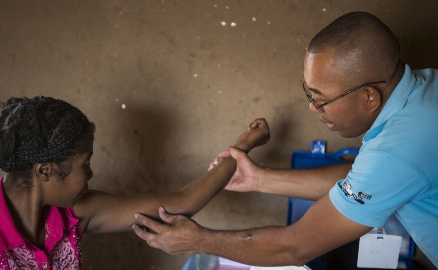 Nana (left) gets her birth control implant checked by Dr. Jean Rangomana during the Marie Stopes International mobile clinic in Besakoa, Madagascar, on April 9, 2018. Abortion is illegal under all circumstances in Madagascar, and Trump administration policies led to shortages of birth control there, health workers say.