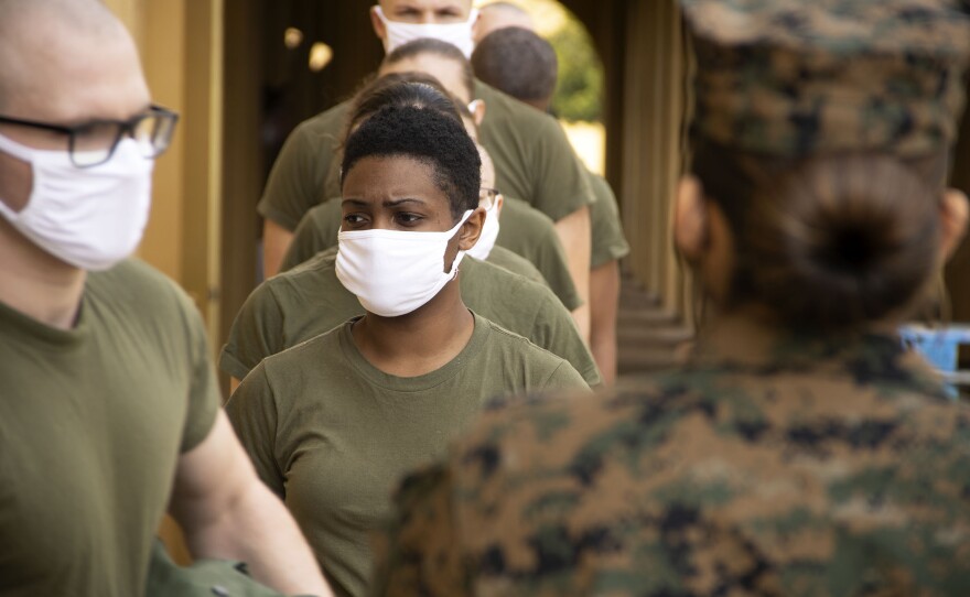 Male and female recruits getting into formation at Marine Recruit Depot San Diego, Feb. 9, 2021. It's the first time in 100 years that the training class will be co-ed at MCRD.