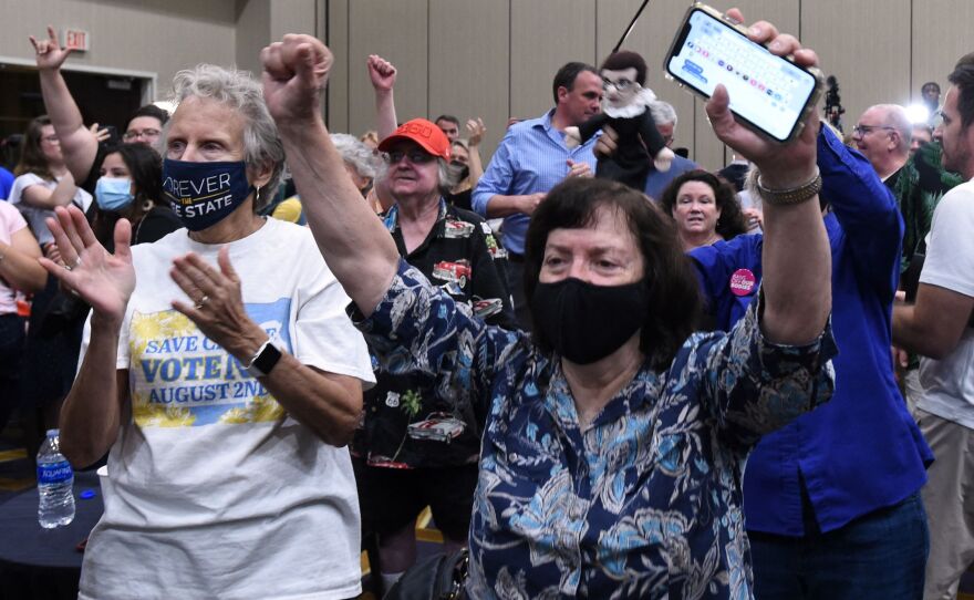 Abortion-rights supporters cheer as the proposed Kansas constitutional amendment that would allow abortion restrictions in the state fails. They were watching election results at the Kansas for Constitutional Freedom watch party in Overland Park on Tuesday night.