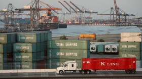 A truck passes shipping containers at China Shipping at the Ports of Long Beach and Los Angeles, the busiest port complex in the U.S., near Long Beach, Calif. Stricter emissions standards have cut down on air pollution from the trucks, which has been one of the most significant sources of air pollution in California for many years.