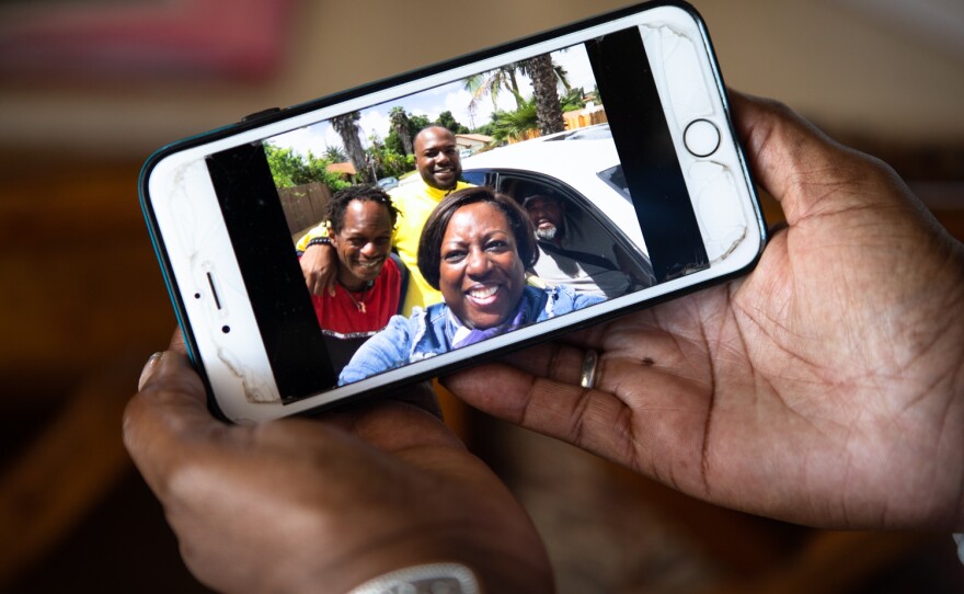 Anita Fisher shows a recent photo of her family on her cell phone at her home in Spring Valley, Aug. 16, 2022.