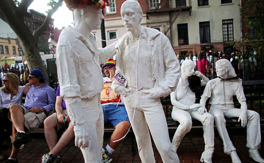 After much controversy, George Segal's sculpture "Gay Liberation" was installed in Christopher Park, located across the street from the Stonewall Inn. A crowd gathered at the site in 2015 to celebrate the U.S. Supreme Court decision legalizing same-sex marriage.