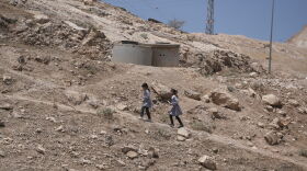 Palestinian students walk on their way home after receiving their year end reports from school, in the West Bank Bedouin hamlets of Khan al-Ahmar, Wednesday, June 10, 2026.