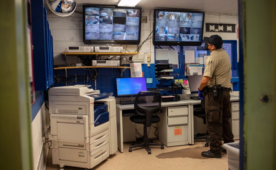 Darwyn Cowboy watches inmates on the surveillance monitor during his shift at the Window Rock District Department of Corrections. The jail is supposed to have three to four correctional officers on duty per shift but has only two.