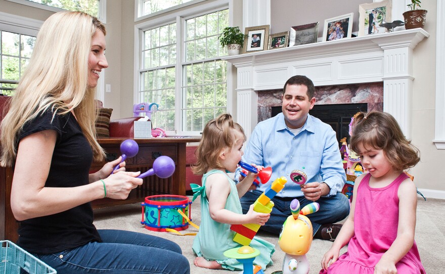 Larry and Carolyn Bloomstein play with their daughters Aria, 2, (left) and Hailey, 5, at home in New Jersey.