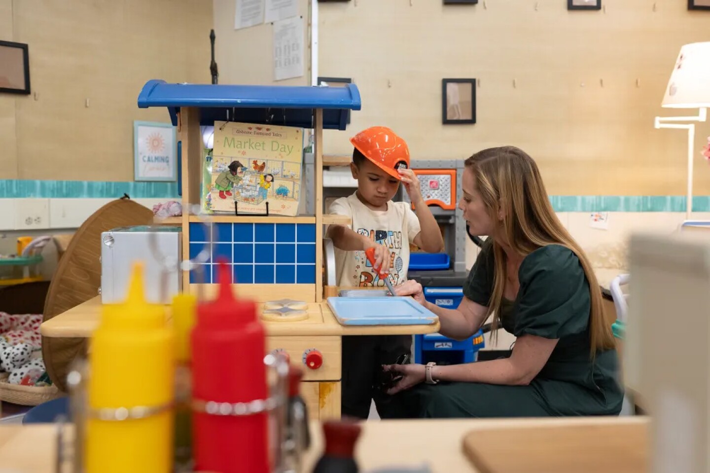 Lauren Ashton plays with a child during a transitional kindergarten class at Silverwood Elementary School on Aug. 11, 2025.